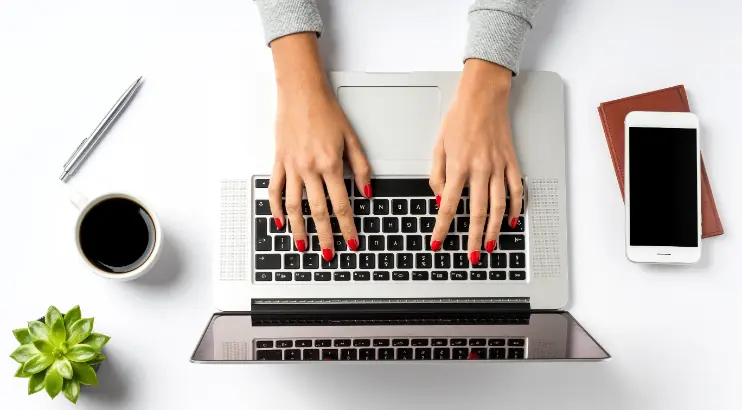 Marketing support solutions showing hands typing on a laptop keyboard