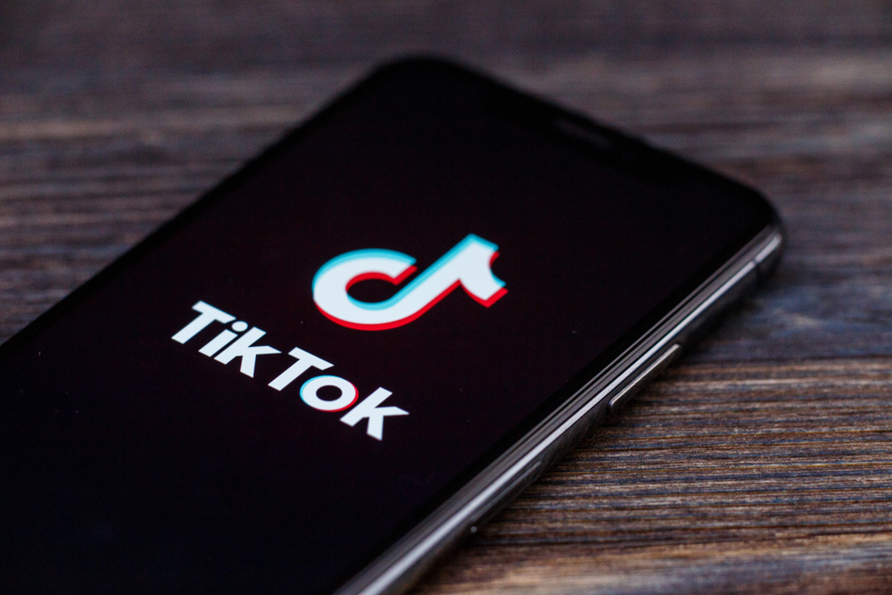 Is TikTok good for business | Phone on table with TikTok logo.