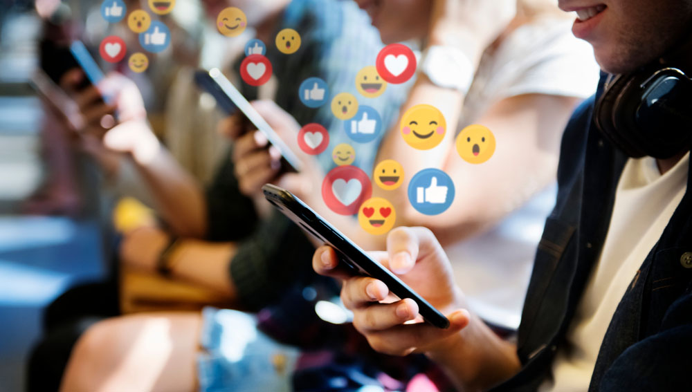 social media expert | people on phones with emojis coming out