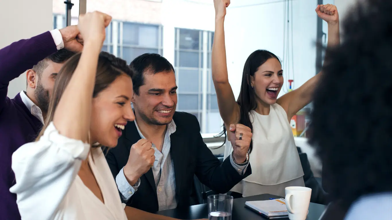 group of people cheering at success in sharing content marketing services