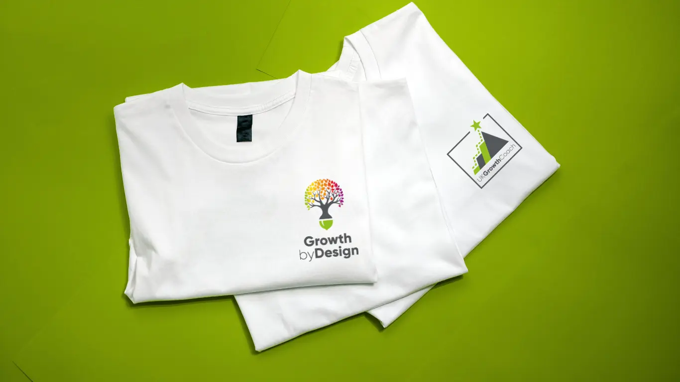 Branded t-shirts with the Growth by Design logo and UK Growth Coach branding