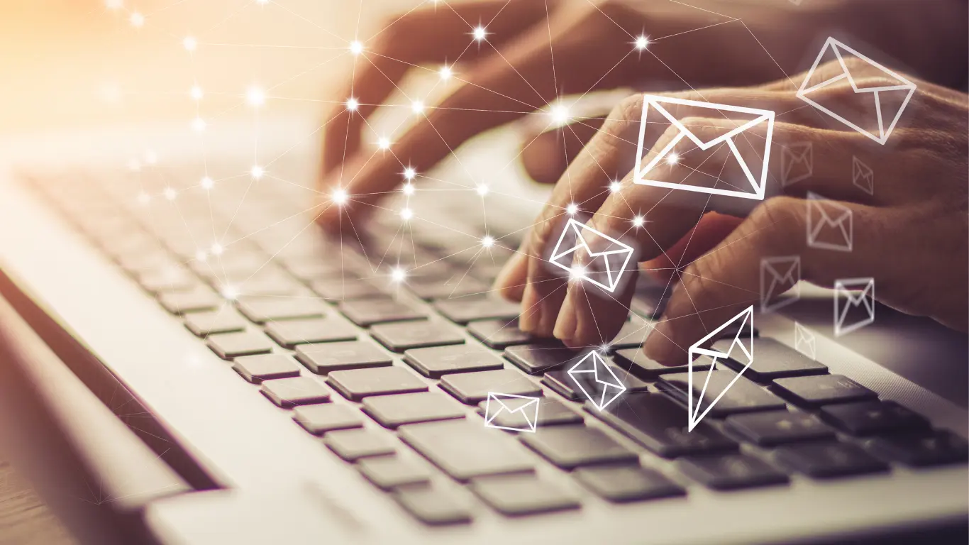Fingers tapping a keyboard with graphics of email envelopes and a network to suggest email marketing