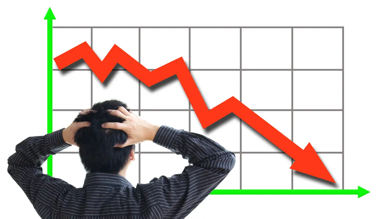 Man standing with his hands on his head in front of a chart showing his Google search rankings falling