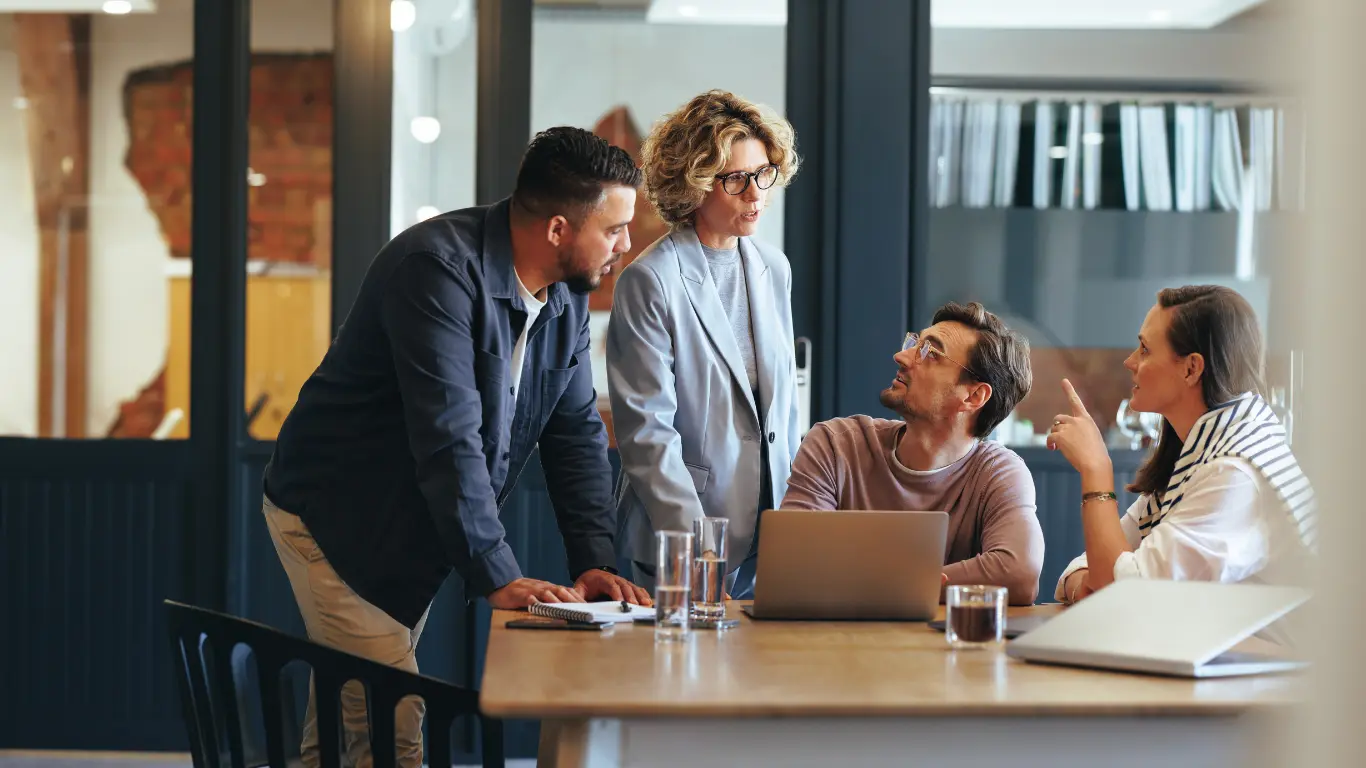 wordpress web design agency team at a desk looking at a laptop
