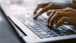 fingers tapping a laptop keyboard, creating an email marketing strategy