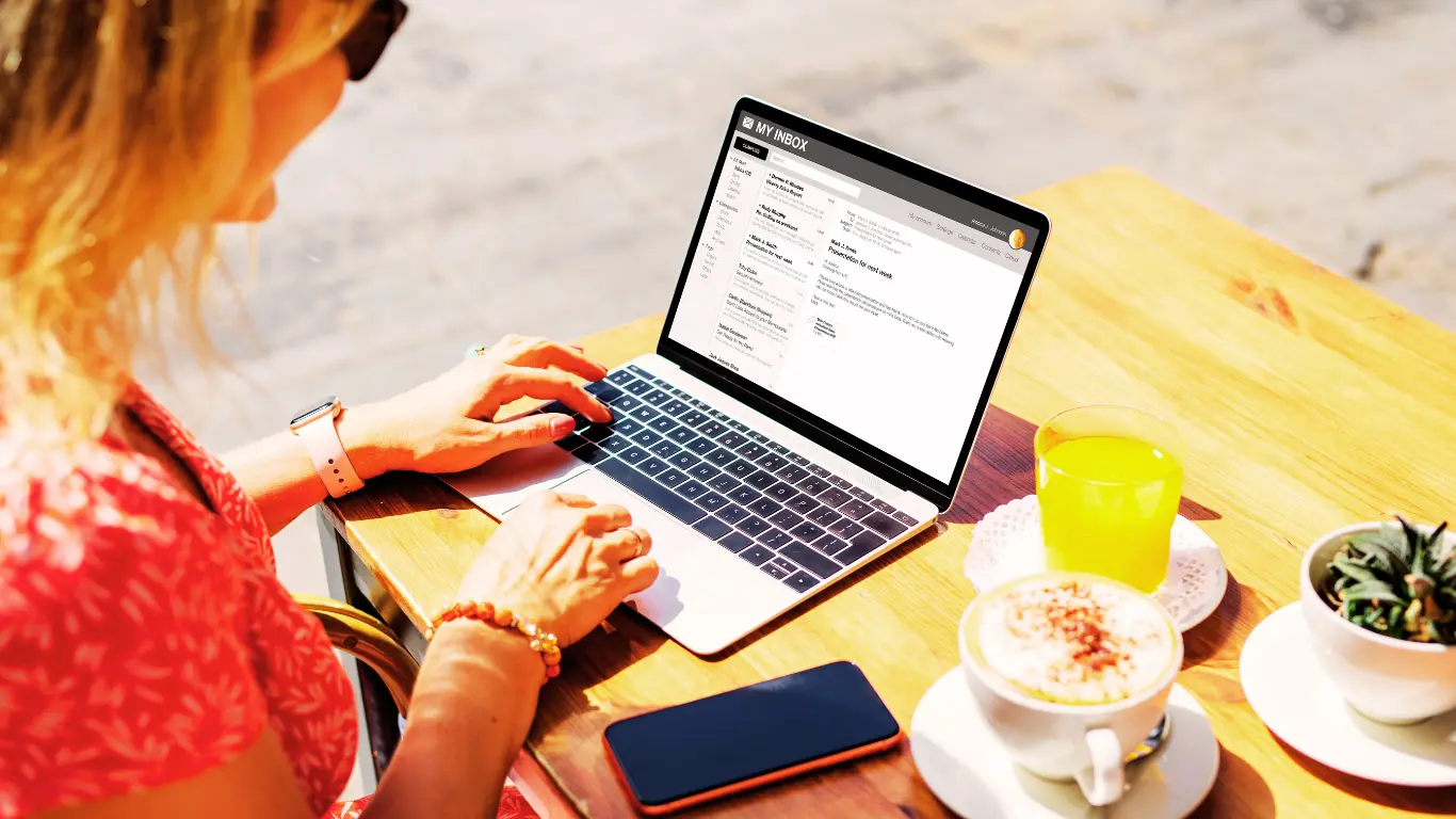 female sitting at a desk with a laptop composing an email as part of an email marketing strategy