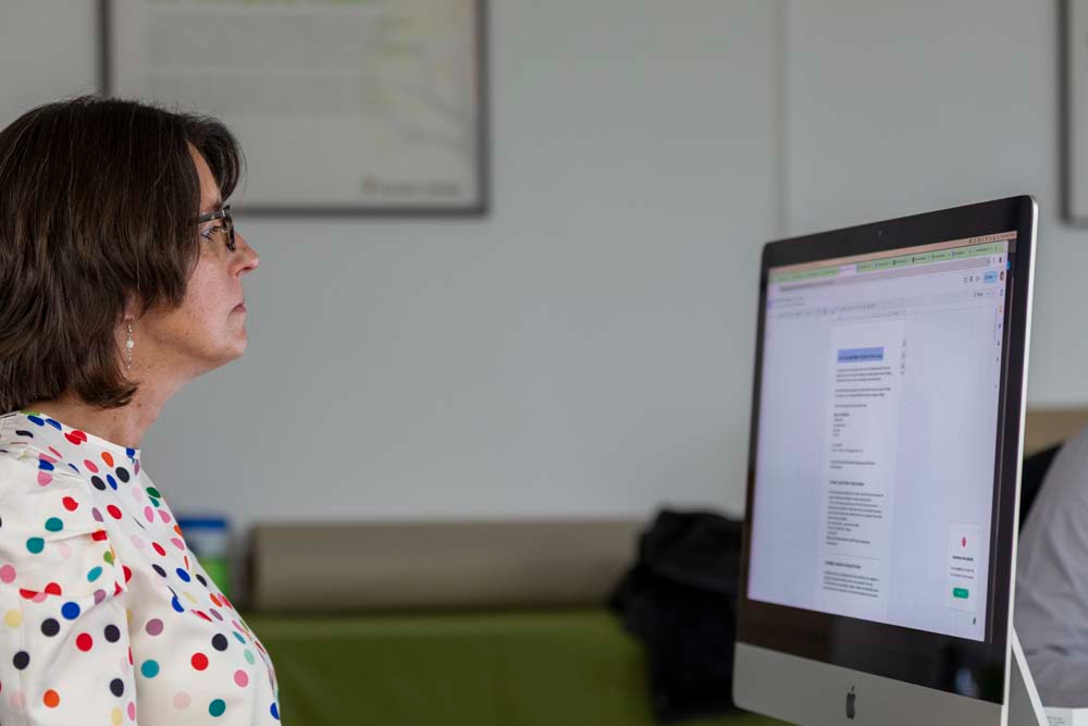 Content marketing for small businesses team member in front of computer creating written content