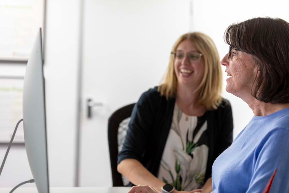 Social media marketing for small businesses two people discussing at a laptop